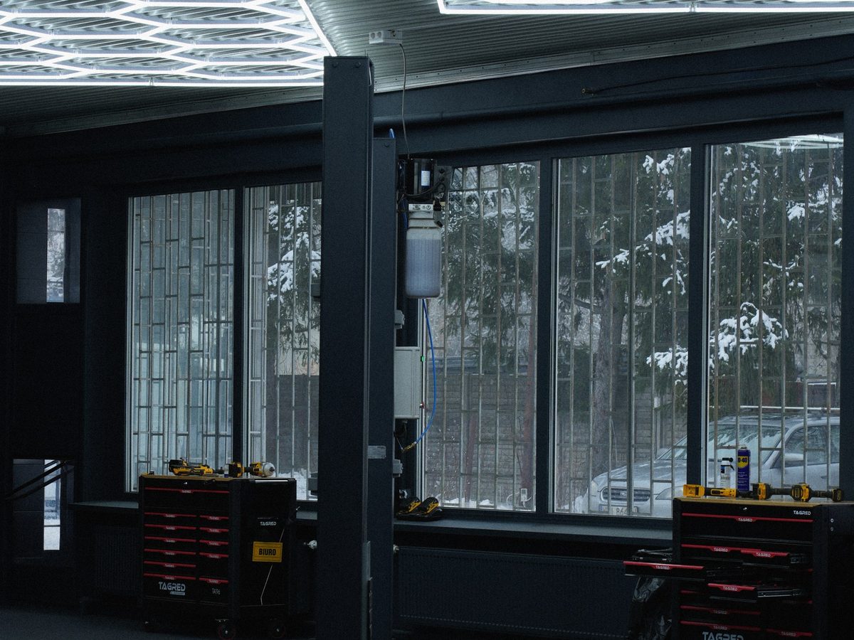Pulsecar workshop interior with a two-post lift