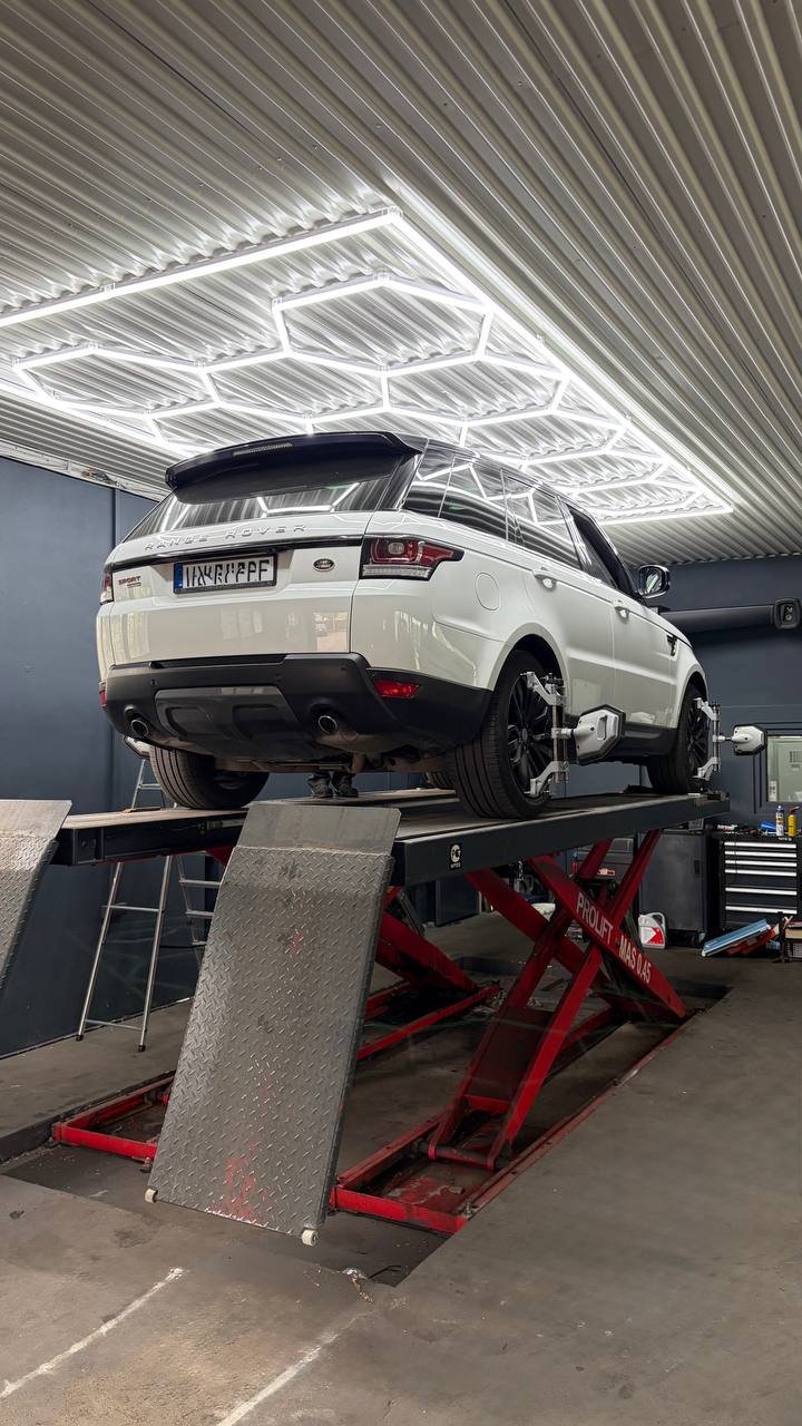 White Range Rover on lift with neon lighting