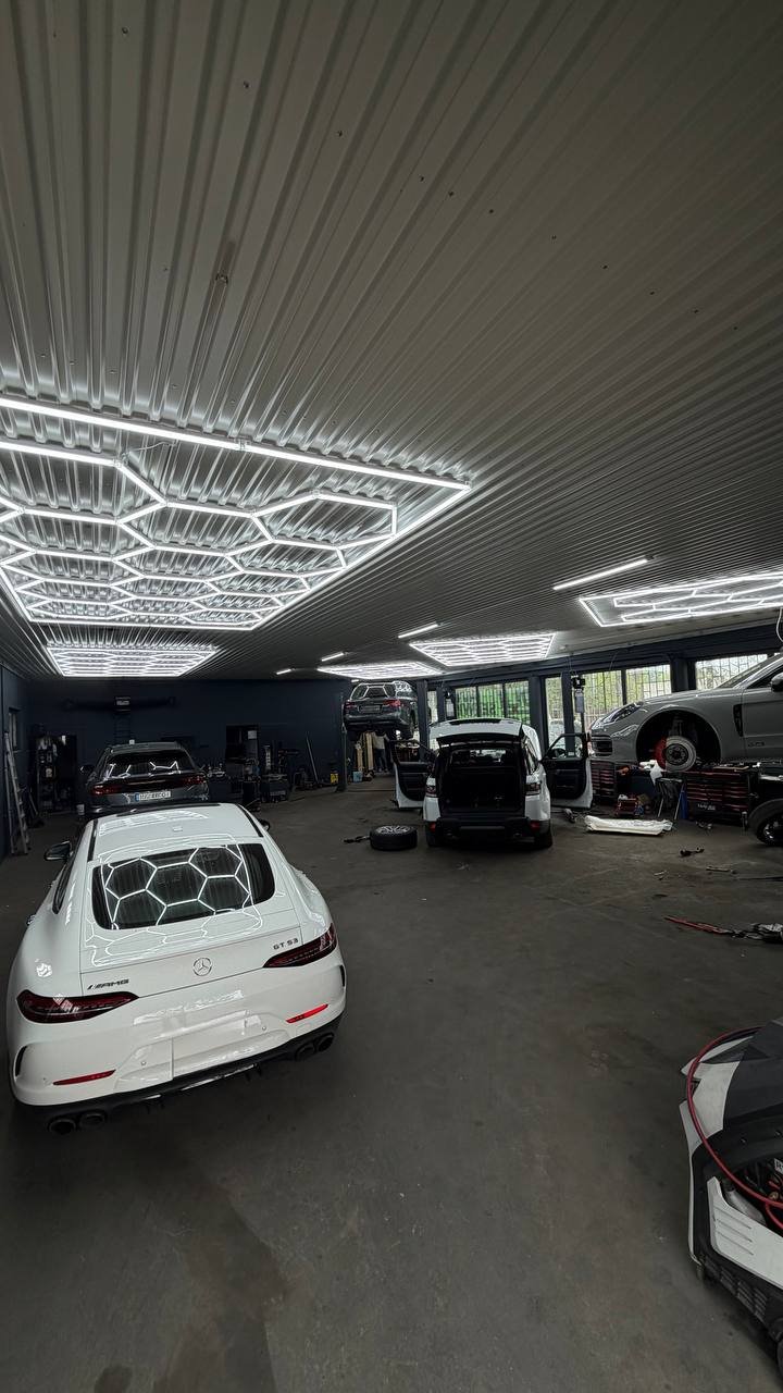 Garage interior with multiple cars and neon ceiling
